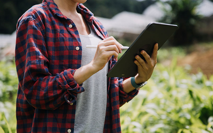 woman using mobile payments tech in the field