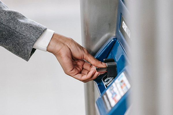 customer paying at a gas station pump with their credit card