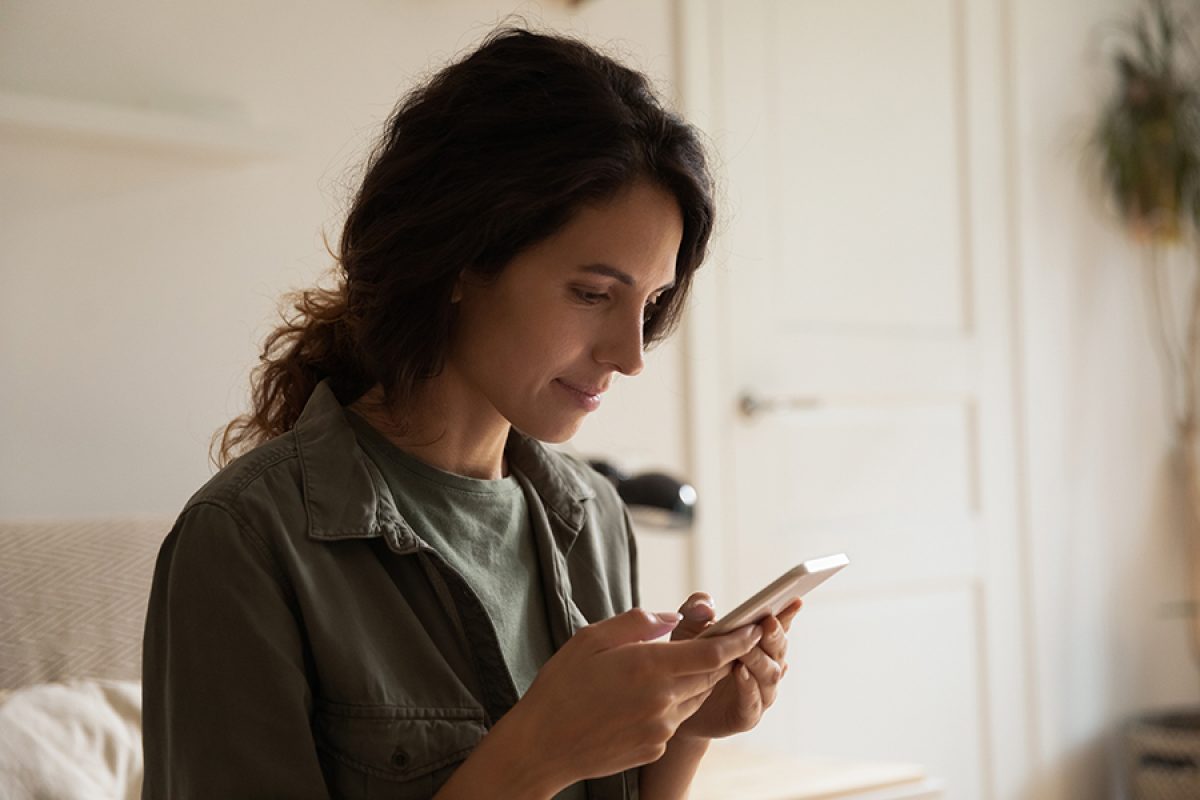 Focused positive cellphone user texting message, using app on smartphone, making call, chatting on social media websites, making virtual order, paying via internet bank service, shopping online