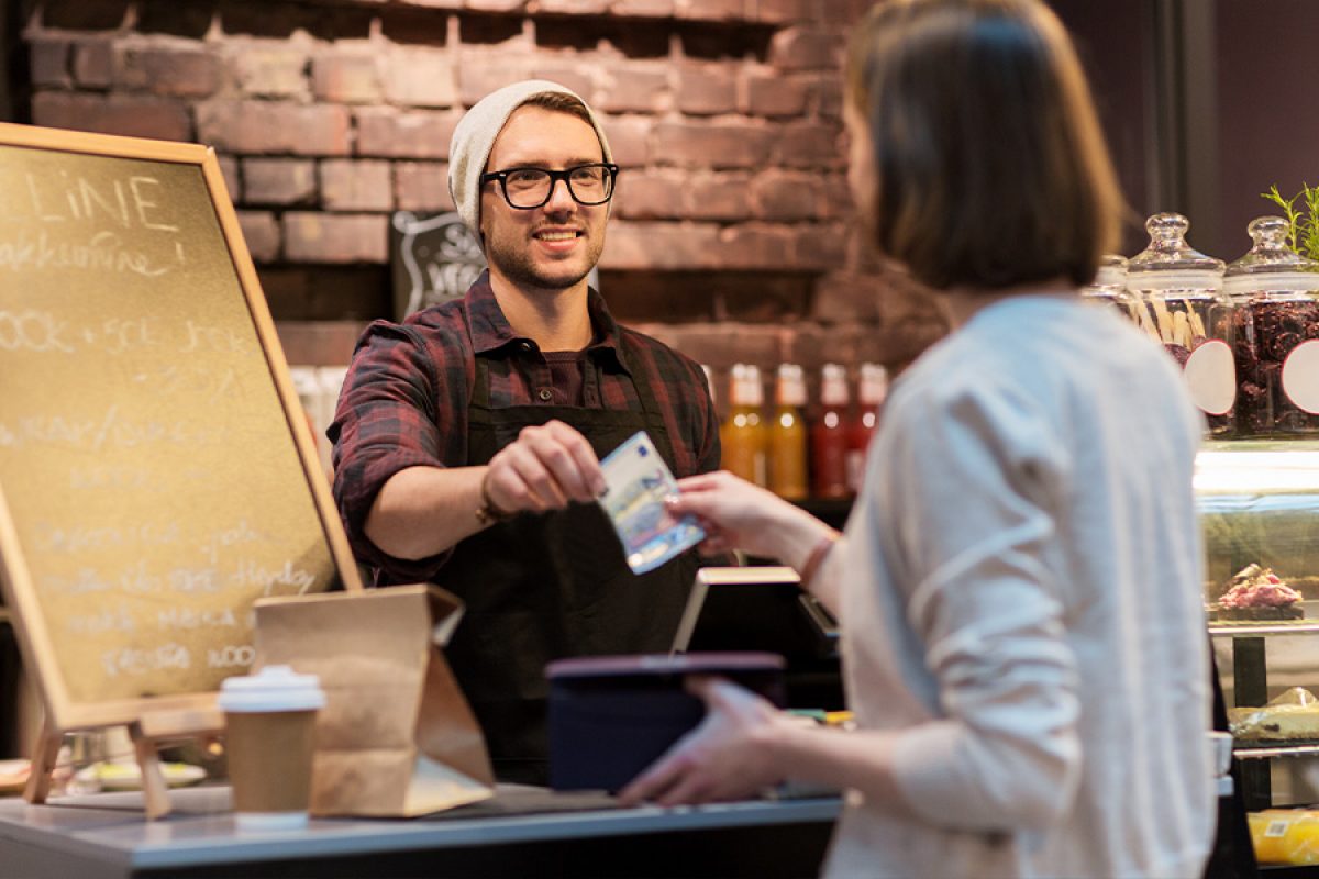 woman paying cafe with cash